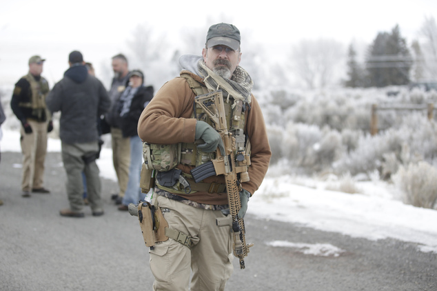 A man stands guard after members of the'3% of Idaho group along with several other organizations arrived at the Malheur National Wildlife Refuge near Burns