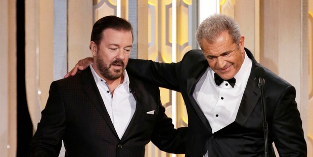 Host Ricky Gervais and presenter Mel Gibson banter on stage