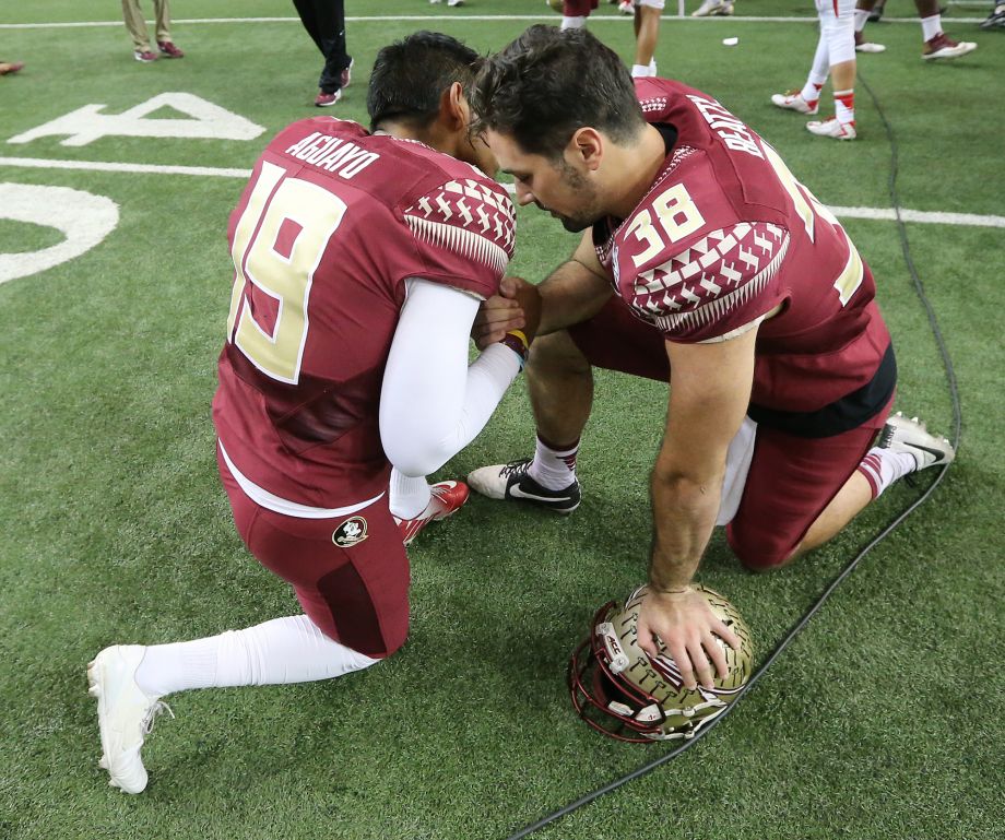 Florida State players Roberto Aguayo and Cason Beatty kneel on the field after losing to Houston 38-24 in the Peach Bowl NCAA college football game Thursday Dec. 31 2015 in Atlanta.  MARIE