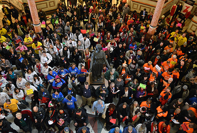 Hundreds of demonstrators pack the Capitol rotunda ahead of Governor Bruce Rauner's 2016 state of the state speech