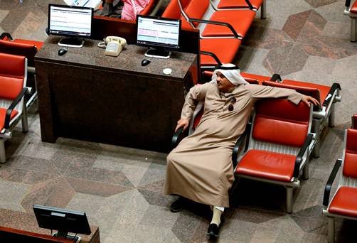 A Kuwaiti trader follows the stock market activity at the Kuwait Stock Exchange in Kuwait City as share prices in the energy-rich Gulf states nosedived yesterday amid chronic oil concerns