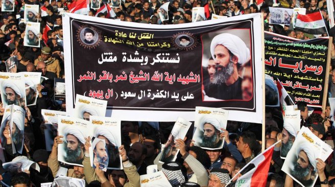 Supporters of Iraqi Shiite cleric Moqtada al Sadr hold posters of prominent Shiite cleric Nimr al Nimr during a demonstration in the capital Baghdad