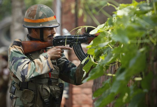 An Indian army soldier holds an AK-47 assault rifle during a fight in the town of Dinanagar in the northern state of Punjab India Monday