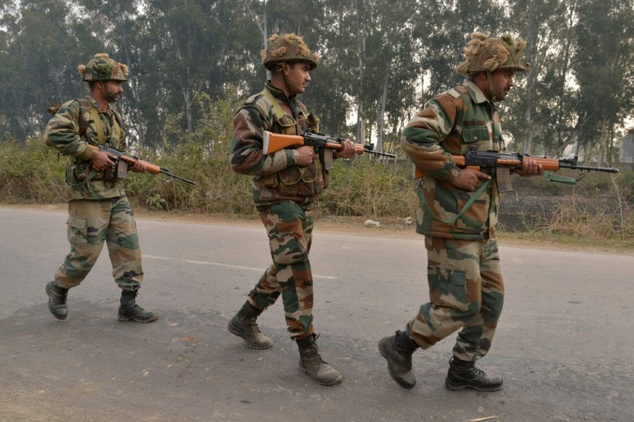 Indian army soldiers patrol on the perimeter of an airforce base in Pathankot