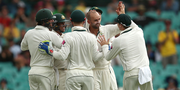 Australia's Nathan Lyon center is congratulated by captain Steve Smith right after taking the wicket of West Indies batsman Jermaine Blackwood