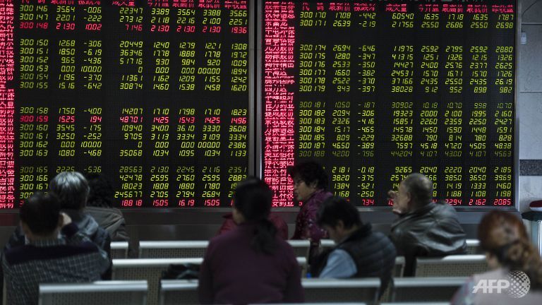 Investors look at screens showing stock market movements at a securities company in Beijing on Jan 7 2016