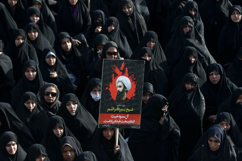 Iranian woman holds up a poster showing Sheikh Nimr al-Nimr a prominent opposition Saudi Shiite cleric who was executed by Saudi Arabia in Tehran Iran. Diplomatic tensions between Saudi Arabia and Ira