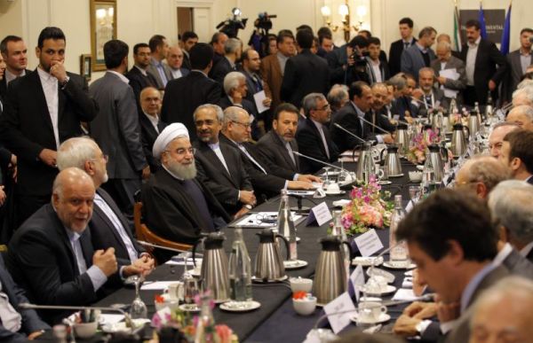 Iranian President Hassan Rouhani third left seated attends