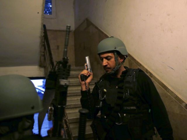 Israeli policemen search for suspects near the scene of a shooting incident in Tel Aviv Israel