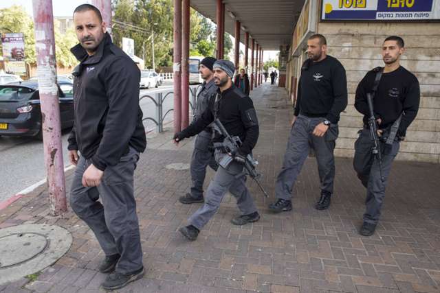 Israeli security forces conduct a search in the Israeli city of Herzliya near Tel Aviv