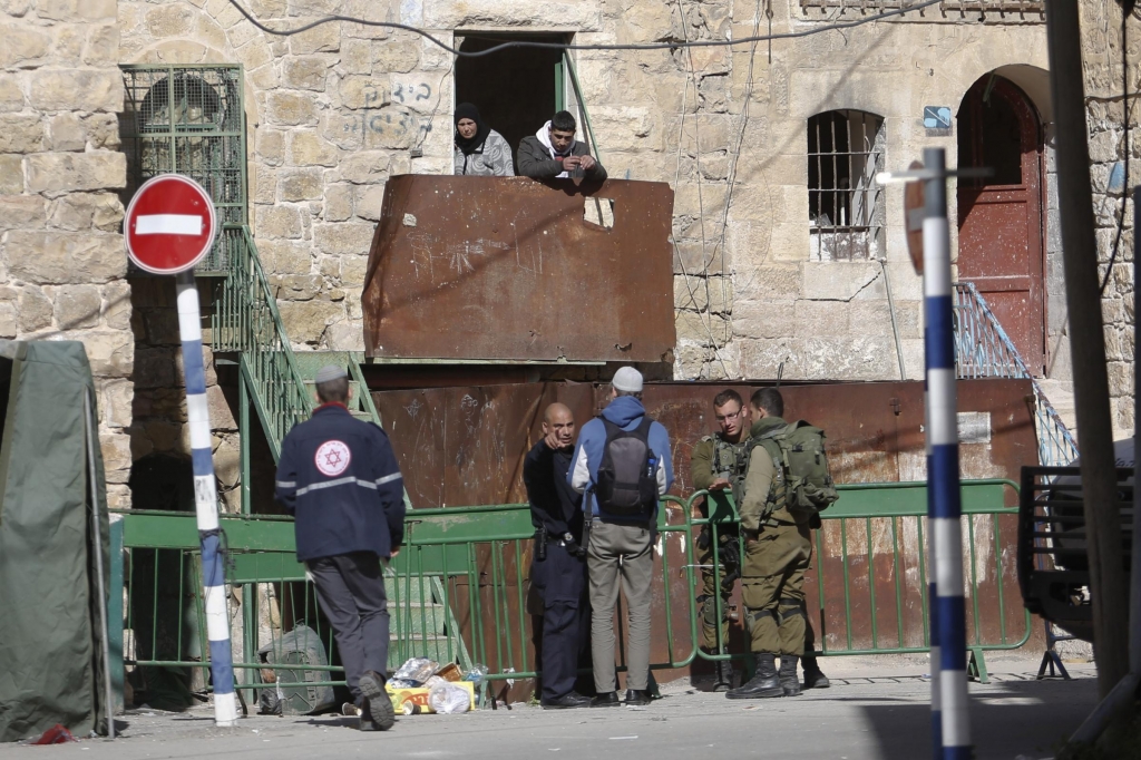 Israeli security forces stand guard at a checkpoint near the West Bank city of Hebron on Dec. 24 2015