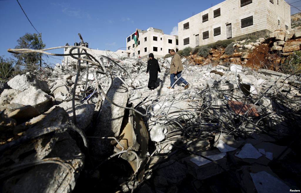 Parents of Palestinian Mohanad Al Halabi inspect their house after it was demolished by Israeli troops in the village of Surda near the West Bank city of Ramallah Jan. 9 2016