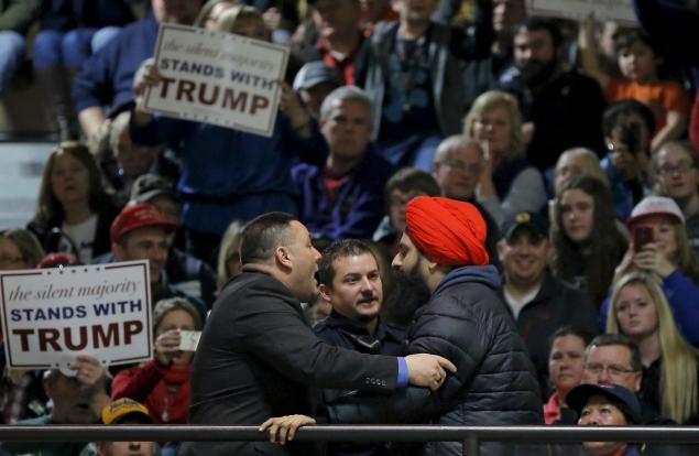 Donald Trump's security detail prepares to escort the protester out of the campaign event in Muscatine Iowa on Sunday