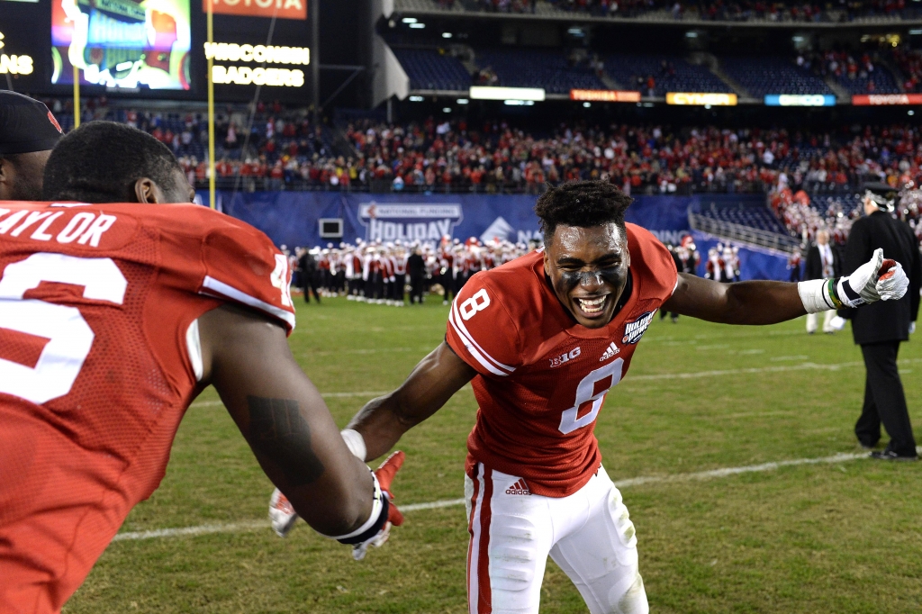 Dec 30 2015 San Diego CA USA Wisconsin Badgers cornerback Sojourn Shelton is congratulated by tight end Austin Traylor after a game changing interception in a 23-21 win over the USC Trojans in the 2015 Holiday Bowl at Qualcomm Stadium. Manda