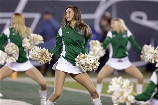 New York Jets cheerleaders perform during the first half of an NFL football game between the Jets and the Buffalo Bills in East Rutherford N.J. The New York Jets have agreed to pay nearly 4,000 to settle a class-a