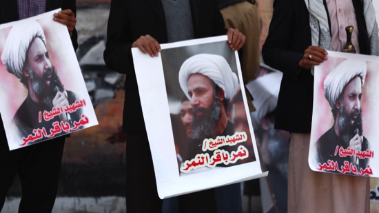 Protesters holding poster of Saudi Shi'ite cleric Nimr al Nimr protest against his execution by Saudi authorities in the village of Sanabis west of Manama Bahrain