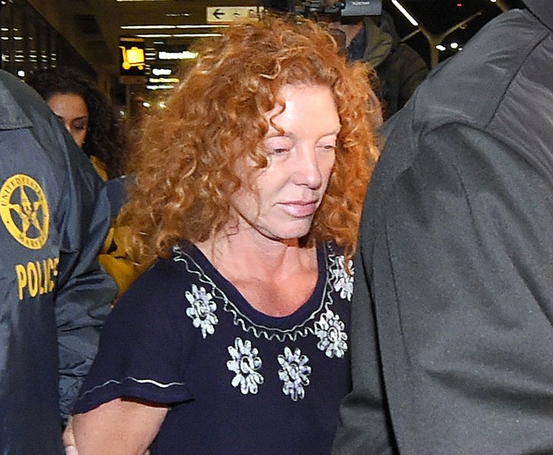 Tonya Couch center is taken by authorities to a waiting car after arriving at Los Angeles International Airport on Dec. 31. Couch was expected to appear in a Los Angeles courtroom Tuesday for a hearing that could send her back to Texas. The Associated P