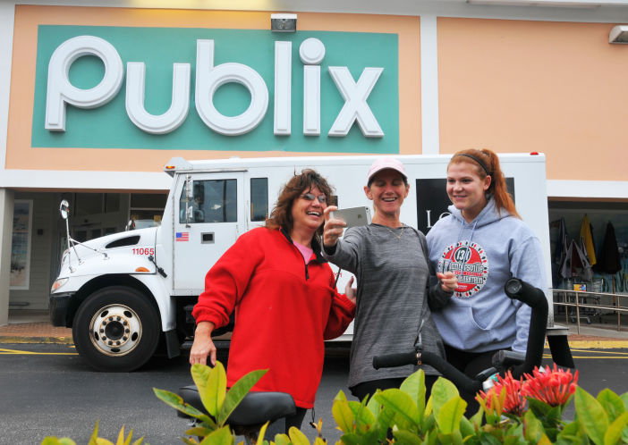 Friends Kim Frodge Jennifer Tweeddale and Haley Parks take a selfie outside a Publix Super Market in Melbourne Beach where one of three winning tickets in the record Powerball jackpot was sold. The holder of the winning ticket will share the $1.6 billion