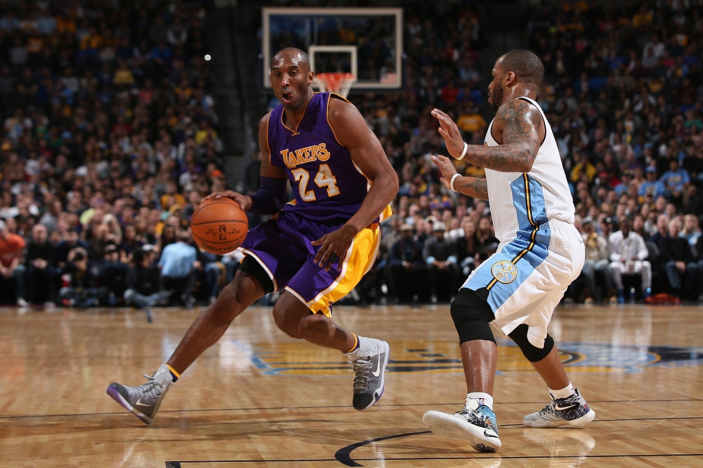 DENVER CO DECEMBER 22 Kobe Bryant #24 of the Los Angeles Lakers controls the ball against Jameer Nelson #1 of the Denver Nuggets at Pepsi Center