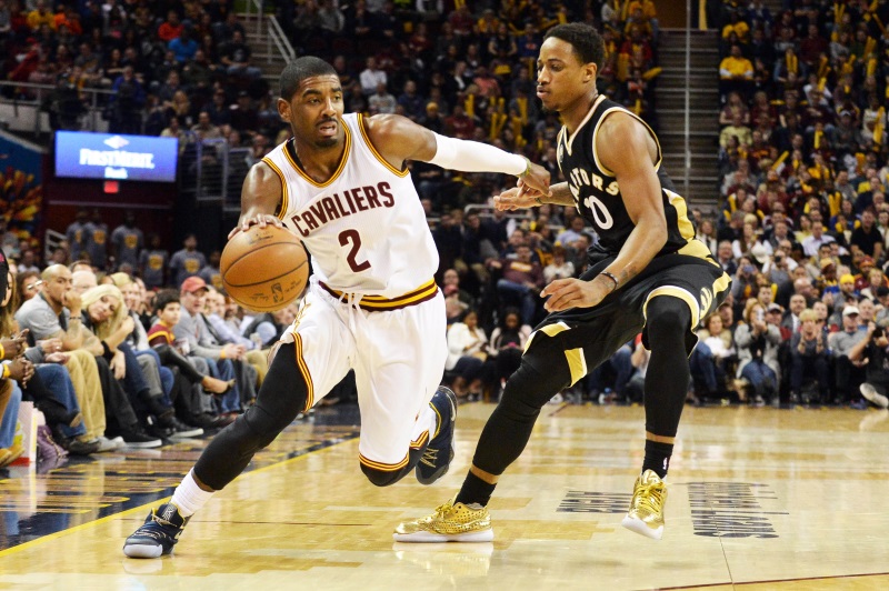 Kyrie Irving dribbles past De Mar DeRozan in the Cavs win over the Raptors