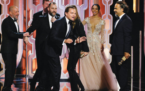 Leonardo Di Caprio on stage with the cast and crew of The Revenant which won Best Motion