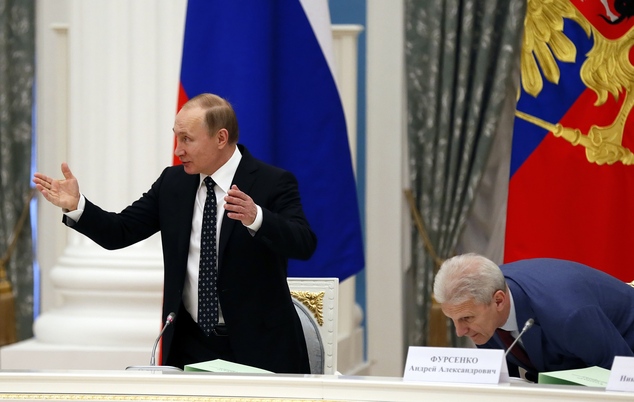 Russian President Vladimir Putin left and President's aide Andrei Fursenko attend a meeting of the presidential education council in the Kremlin in Moscow