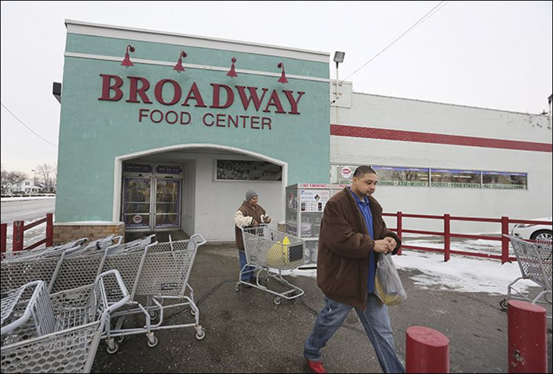 Gerri Wormely and her son Antonio leave the Broadway Food Center in South Toledo where a $1 million-winning Powerball ticket was sold. This was the first winning ticket the store has sold one of the store’s owners said