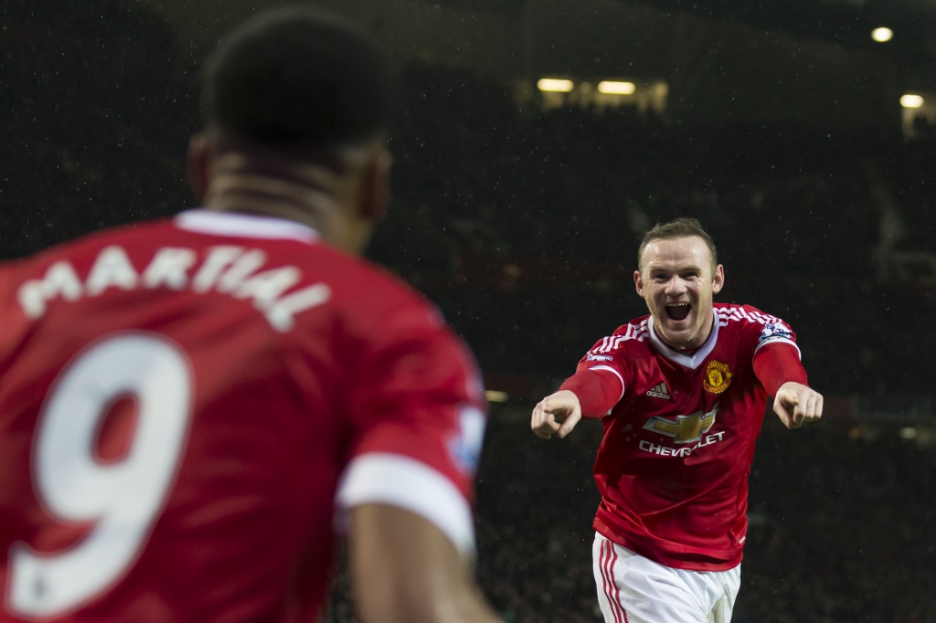 Manchester United's Wayne Rooney right celebrates with teammate Anthony Martial after scoring during the English Premier League soccer match between Manchester United and Swansea City at Old Trafford Stadium Manchester England Saturday Jan. 2