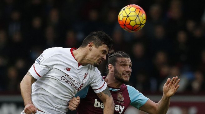 West Ham United striker Andy Carroll vies in the air with Liverpool defender Dejan Lovren during the English Premier League football match between West Ham United and Liverpool at The Boleyn Ground in Upton Park. AFP