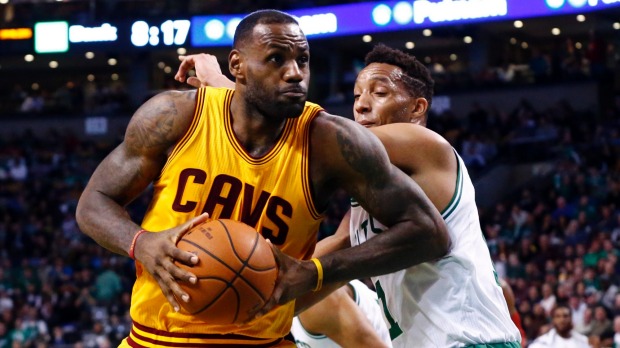 Cleveland Cavaliers forward Le Bron James drives to the hoop against Boston Celtics guard Evan Turner