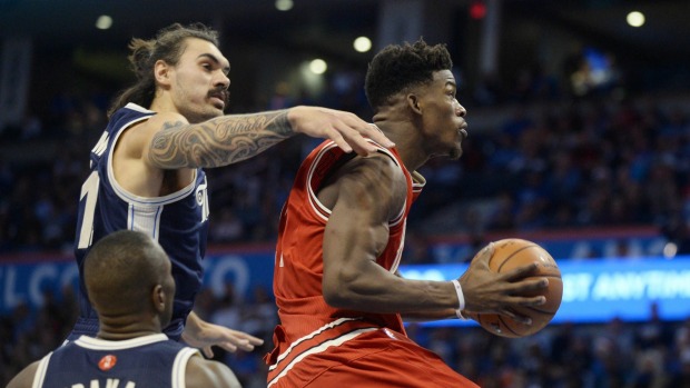 Chicago Bulls guard Jimmy Butler drives to the basket in front of Oklahoma City Thunder center Steven Adams