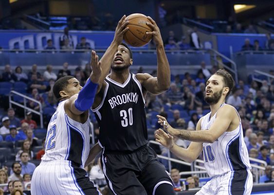 Young gets between Orlando Magic's Tobias Harris left and Evan Fournier for a shot during the first half of an NBA basketball game Wednesday Dec. 30 2015 in Orlando Fla