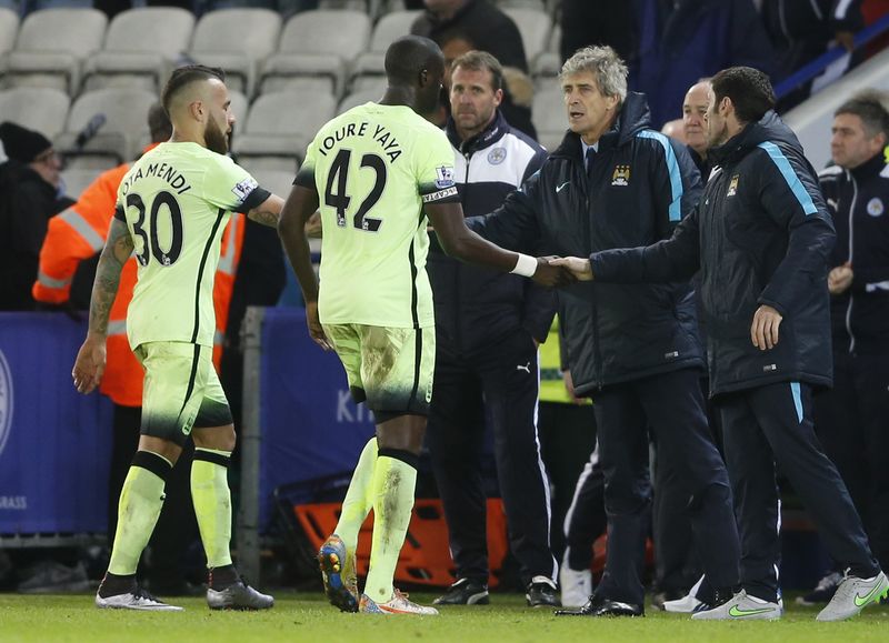 Manchester City's Nicolas Otamendi and Yaya Toure with manager Manuel Pellegrini at the end of the game Leicester City at King Power Stadium. – Reuters pic