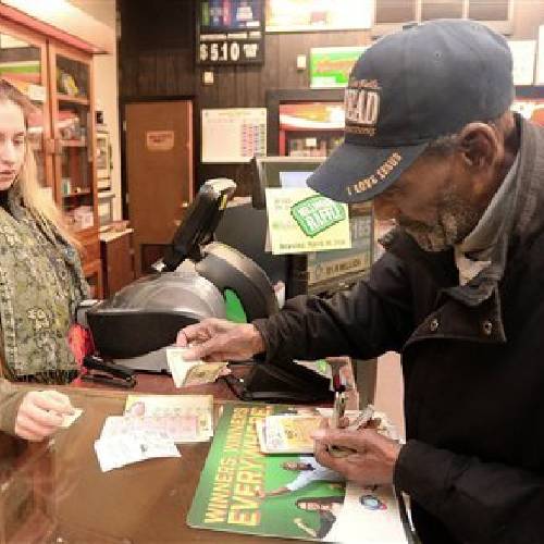 93 buys a variety of lottery tickets including a Powerball ticket from clerk Anna Adiutori at Dee's Cigar Store Friday Jan. 8 2016 in Erie Pa. as the multi-state jackpot reaches $800 million. With ticket sales doubling previ