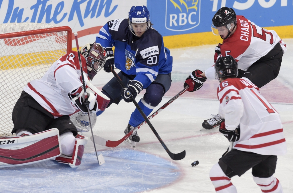 Finland's Sebastian Aho vies with goalkeeper Mackenzie Blackwood Mitch Marner and Thomas Chabot of Canada during the 2016 IIHF World Junior Ice Hockey Championship quarterfinal match between Finland and Canada in Helsinki Finland