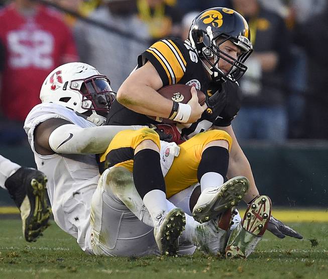 Mark J. Terrill  Associated Press Iowa quarterback C.J. Beathard right is sacked by Stanford defensive end Aziz Shittu