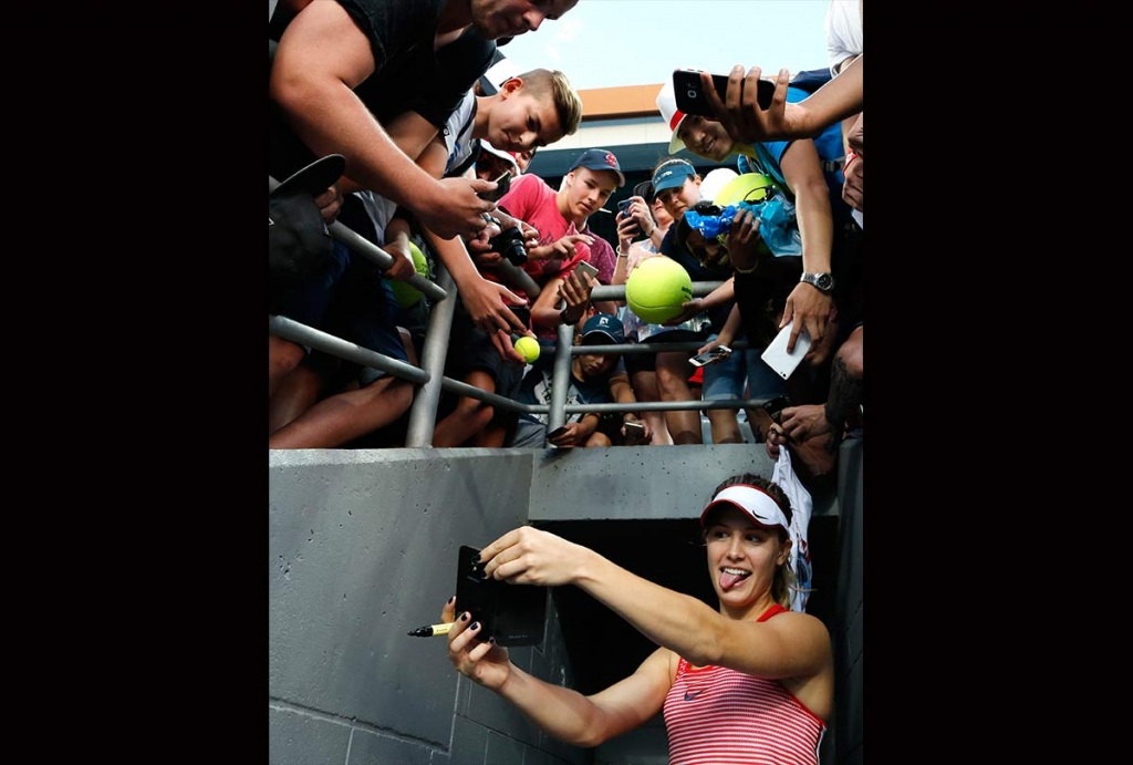 Eugenie Bouchard of Canada takes a selfie for a fan after defeating Aleksandra Krunic of Serbia during their first round match at the Australian Open tennis championships in Melbourne Australia Monday Jan. 18 2016