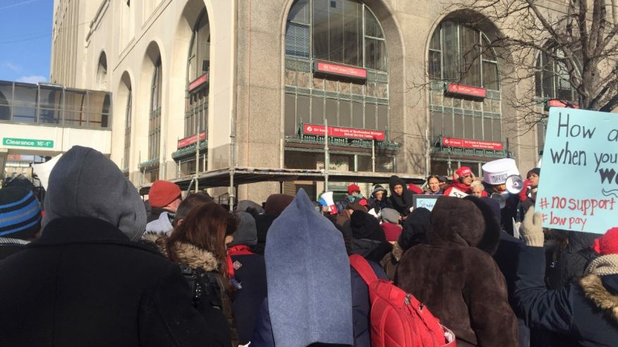 A group of about 200 teachers joined by parents and children protest outside the Detroit Public Schools headquarters Monday