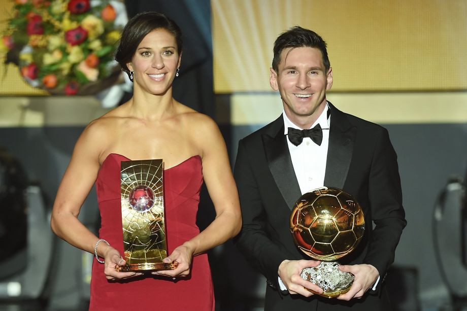 Carli Lloyd of the United States and Argentina’s Lionel Messi hold their Ballon d’Or trophies given to soccer’s top players