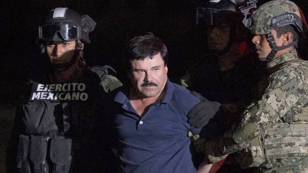 Mexican drug lord Joaquin'El Chapo Guzman is escorted by army soldiers to a waiting helicopter