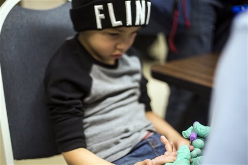 Grayling Stefek 5 has his blood drawn during a free lead testing event and family fun night for children on Tuesday Jan. 26 2016 at Eisenhower Elementary school in Flint Mich. Free water filters were available to families during the event along