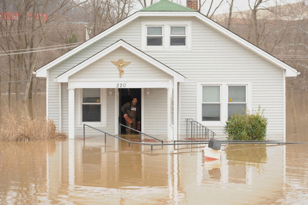 A man removes debris from a business on December 30 in Fenton Missouri. The St. Louis area and surrounding region experiencing record flood crests of the Mississippi Missouri and Meramac Rivers after days of record rainfall. (Michael B. Thomas  Getty Ima