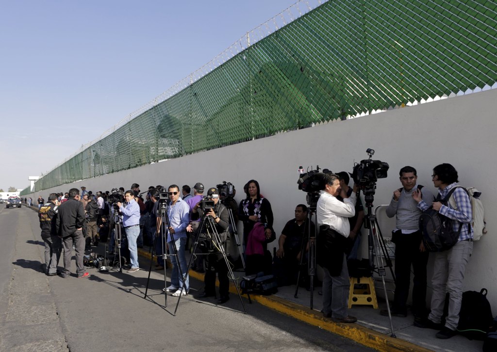 Journalists wait outside ahead of the arrival of recaptured drug lord Joaquin ‘El Chapo’ Guzman at the Navy's airstrip in Mexico City yesterday. Mexico recaptured the world's most notorious drug lord Guzman with US help in a violent standoff six mon