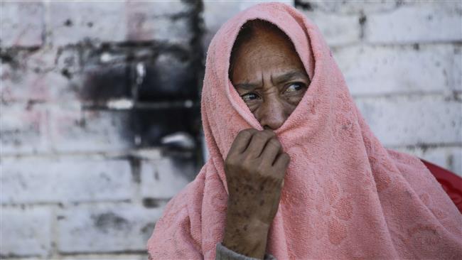 A Nicaraguan woman covers her face with a towel as Health Ministry workers fumigate against the Aedes aegypti mosquito to prevent the spread of the Zika and Chikungunya viruses in capital Managua