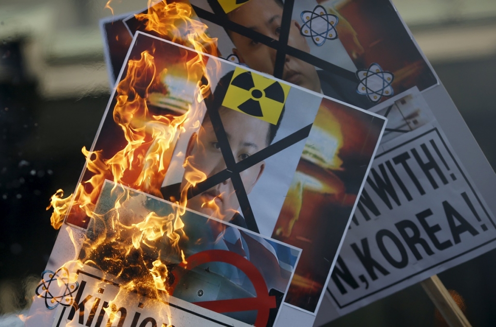 A protester burns banners depicting North Korean leader Kim Jong Un during an anti North Korea rally in central Seoul South Korea today. – Reuters pic