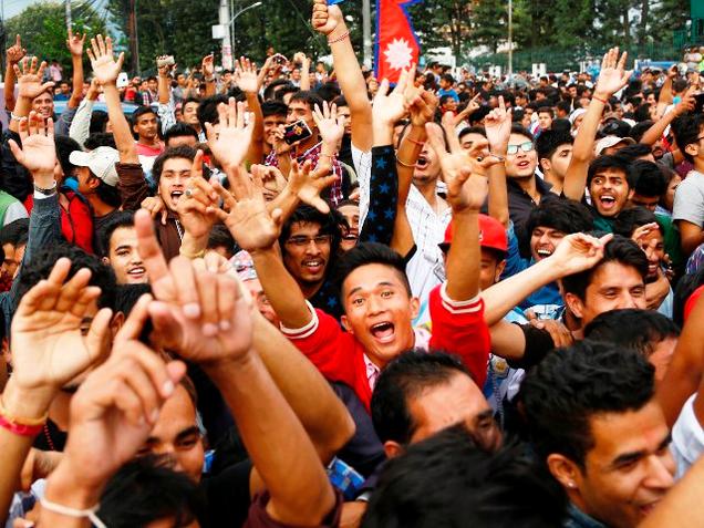 People celebrate the adoption of Nepal's new Constitution outside the Constituent Assembly hall in Kathmandu. File