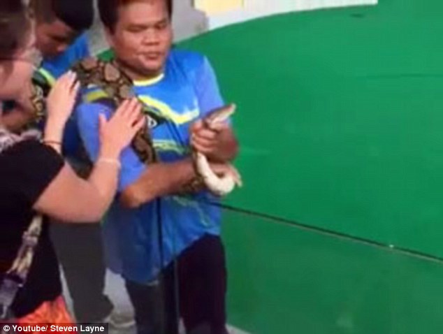 Nice snake Ms Jin Jing pets the python's body while the snake wrangler holds the neck of the snake