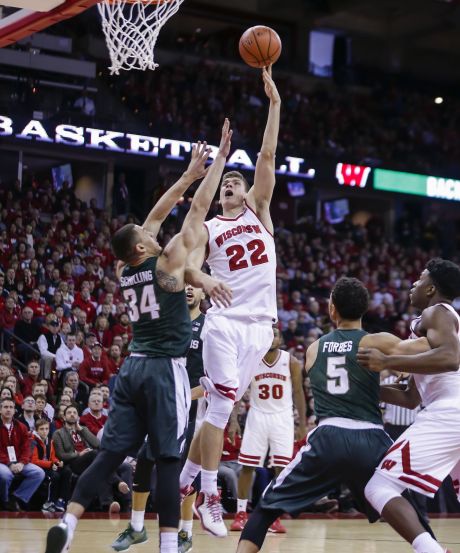 Wisconsin’s Ethan Happ shoots over Michigan State’s Gavin Schilling during the Badgers’ win