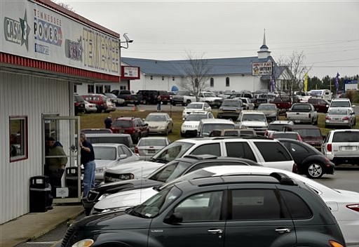 Customers enter a store selling lottery tickets a day before Saturday's Powerball drawing in Fayetteville Tenn. Friday Jan. 8 2016. With Powerball sales breaking previous records the odds are growing that someone will win Saturday night's