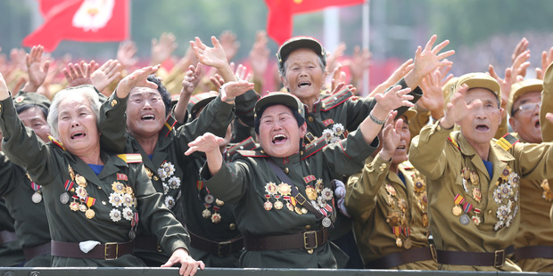 North Korean war veterans cry as they parade past their leader Kim Jong-Un